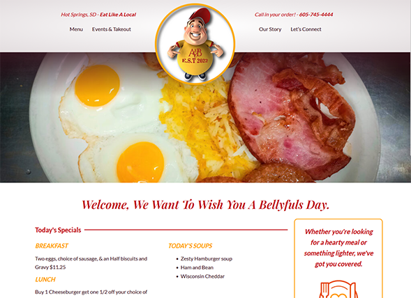 Website screenshot for A Bellyful, a restaurant in Hot Springs, SD. The site shows breakfast food (eggs, bacon, ham), todays specials, soups, contact info, and a cartoon chef logo at the top center.