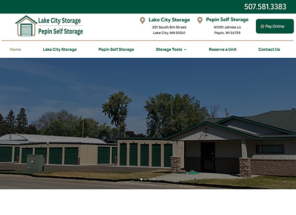 Screenshot of a self-storage facility website, showing a row of green storage unit doors, a building, trees, and contact information for Lake City Storage and Pepin Self Storage at the top.